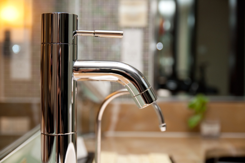 Leaking tap being repaired in West Horsley